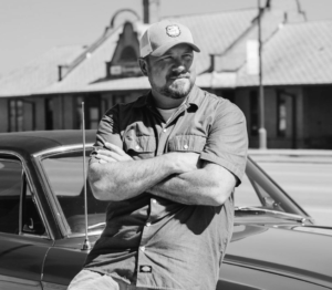 mike brevik. of cyberdogz sitting on car